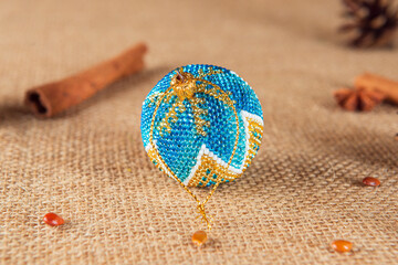 Exquisite handmade Christmas bubble toy from beads, also known as a Christmas globe or Christmas bulb, is a part of holiday decor.