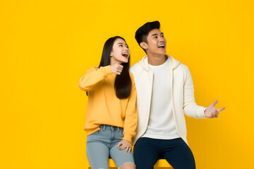 a pair of models promoting a product, a man and woman posing energetically against a vibrant yellow background