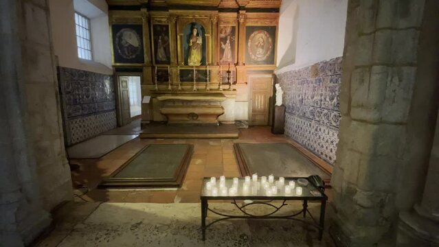 Candles burning in a church in &Eacute;vora, Portugal, Europe, with traditional Azulejo tiles
