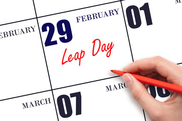 February 29. Hand writing text Leap Day on calendar date. Save the date.