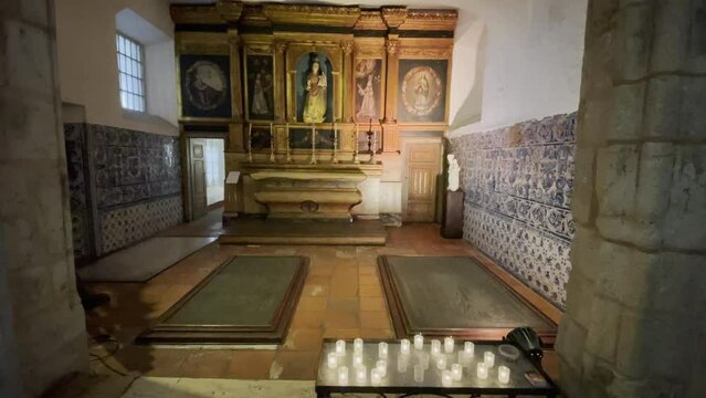Candles burning in a church in &Eacute;vora, Portugal, Europe, with traditional Azulejo tiles