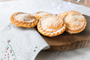Christmas mince pies on a wooden board on a table © Liz Mitchell