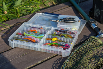 Fishing tackles and fishing baits in box .Classic Colored Fishing Lure , Beautiful Background...