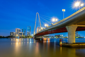 Landscape of Ba Son cable-stayed bridge spanning the Saigon River at night in Ho Chi Minh City, Vietnam.