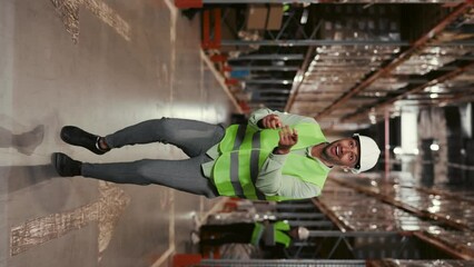 Warehouse Worker Engaging in Playful Dance Routine. Energetic and Lively Atmosphere Fills the Warehouse Employer Embrace Fun Moments while Maintaining Productivity. Vertical Video - Powered by Adobe