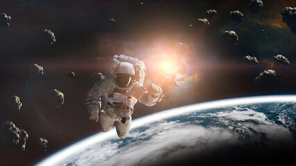 Cosmonaut with asteroids in low-Earth orbit. Elements of this image furnished by NASA.