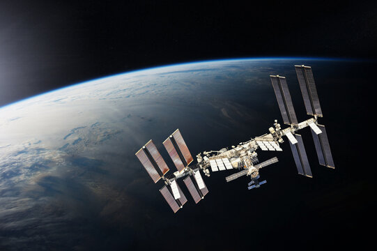 ISS over the planet Earth. Elements of this image furnished by NASA. - Powered by Adobe