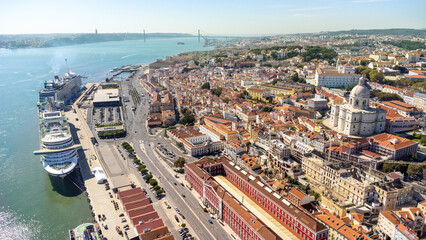 Aerial view of Lisbon city center. View of National Pantheon at right. Spectacular cruise ships moored in the port. Rooftops of Lisbon. Famous European travel destination and capital of Portugal.