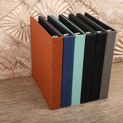 Personalized binding, leather folder cover, leather binding, binder, binder, office binding, corporate gift. Concept shot leather binding, top view, colorful
