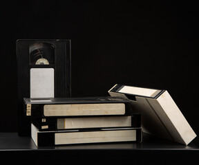 Pile of VHS video cassettes. Vintage media. Dark back