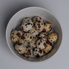  Top View of Quail eggs in a bowl isolated on white background