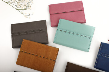 Colored leather business card holder, Genuine leather business card holder, concept shot, top view, different color, clamshell and stitched card holder. White backgorund.