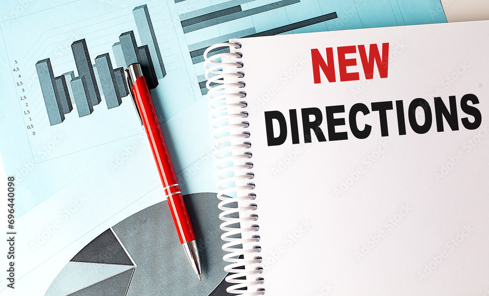 Poster new directions text on a notebook with pen on a chart background