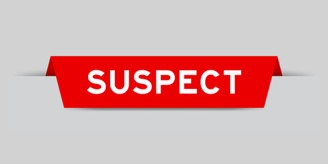 Red color inserted label with word suspect on gray background