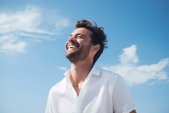 A Cheerful Man In A Crisp White Shirt Against A Soft Sky-blue Backdrop, Beaming With Joy.