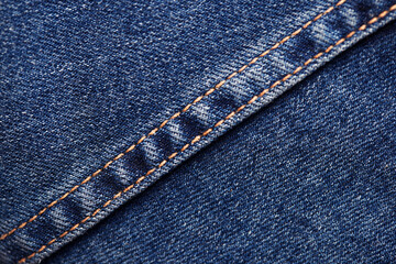 Seams on jeans close-up. Stitching on denim. Fabric texture. Blue jeans background and texture....