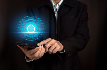 Businessman hand pressing power button icon on smart phone, virtual screen, Start up business concept.