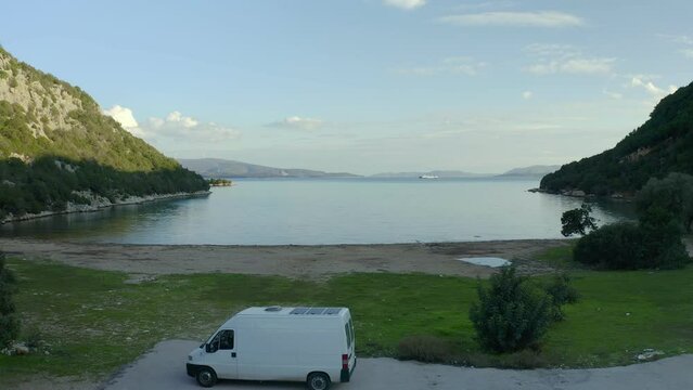 Drone aerial view of a camper van alone on Marathias wild beach in Greece
