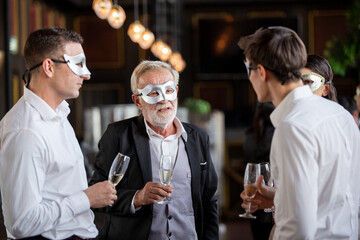 Group of office worker in fancy mask having celebration party. people cheers toasting wine glasses and talking together. business corporate company meeting in New Year party concept