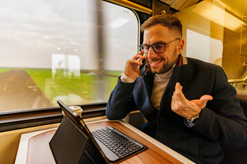 Commuter on his way to work using technology to catch up on his work load, he's using the commute time to have some call meetings