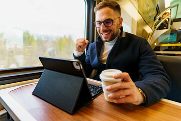 Businessman commuting by train, talking on phone about business plans and ideas he's happy about research his team did