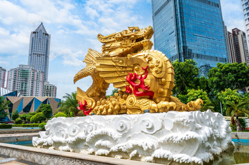 Golden sculptures of ancient legendary animals in Chinese city streets