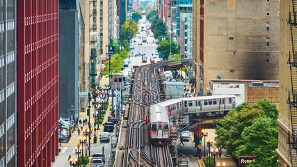 Train on tracks in Chicago aerial of big, inner city transit, travel and tourism with buildings - obrazy, fototapety, plakaty