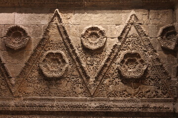 The wall is covered in a delightful assortment of various ornaments, creating a visually striking...