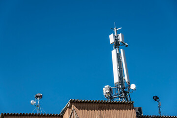 Communication transmitters and receivers on the roof of a buildi