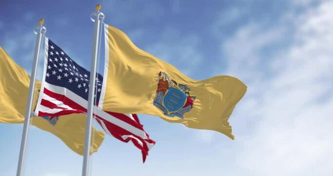 New Jersey state flags waving with the american flag on a clear day