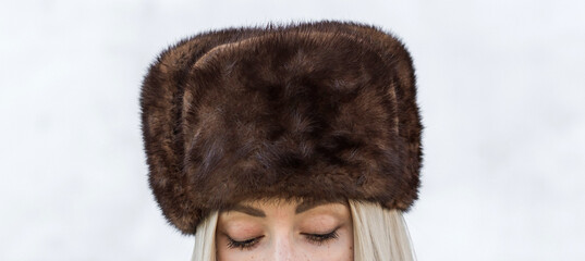 Slavic bimbo aesthetic. Portrait of a European type Blond head Young woman with natural skin in fur...