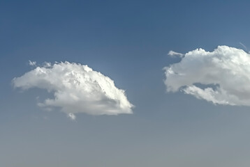 Naklejka na ściany i meble Blue sky showing through a cloudy sky.