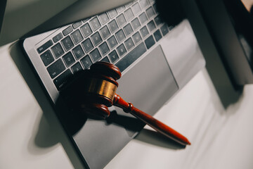 image of judge's hammer, scales lady of justice, law book, laptop computer and contract documents...