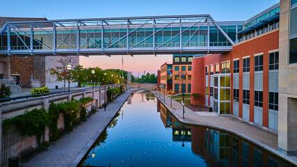 Aerial Twilight Urban with Modern Pedestrian Bridge and Canal Reflections