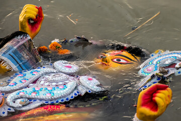 Immersion of idol goddess durga in river after completion of four days festival. Durga is created...
