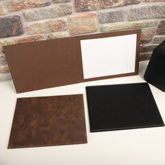 Fototapeta premium Colorful leather diploma holder. Concept shot, top view, different color, clamshell and stitched diploma holder, A new leather award board certificate and diploma frame