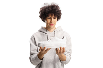Guy looking at a white sneaker