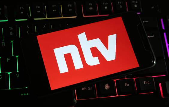 Viersen, Germany - December 9. 2023: Closeup of smartphone on computer keyboard with logo lettering of german TV new channel NTV