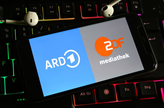 Viersen, Germany - December 9. 2023: Closeup of smartphone on computer keyboard with logo lettering of german public television channels ARD and ZDF