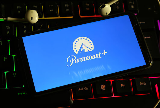 Viersen, Germany - December 9. 2023: Closeup of smartphone on computer keyboard with logo lettering of paramount plus streaming service