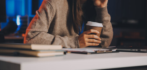 Team of software developers working on big project late at night in neon light trying to finish before deadline