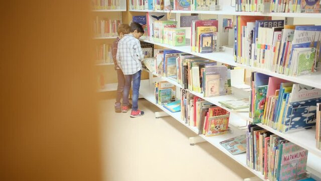 A child in the bookstore publishes with books. concept of education, imagination and public library. Share discoveries in childhood. Stimulate children's image, education and interest in science.