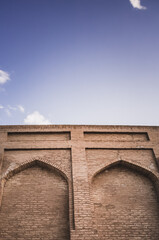 Relief facade of an ancient brick building with windows in the ancient city of Fort Khiva in...