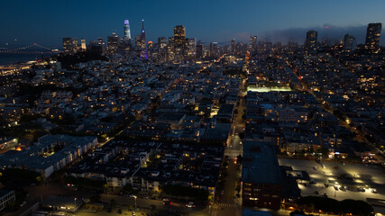 panoramic aerial night view of greater San Francisco area with illuminated skyline of SoMa and...