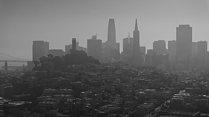 monochrome aerial landscape view of metropolitan area of San Francisco with the famous skyline in the background covered in light haze 