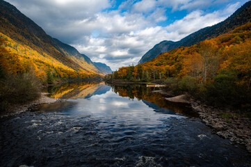 Majestic Fall foliage colors in the Jacques Cartier valley as the river flows slowly, Quebec, Canada