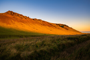 Icelandic sunset over the golden fields, close to the town of Vik.