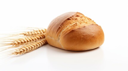 A loaf of bread buns sitting next to a bunch of wheat.