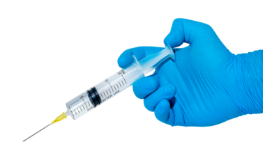 A hand in blue rubber gloves holds a medical syringe with a needle on a white background. Treatment. Injection