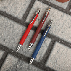 Colorful leather pen. Concept shot, top view, different colors pens. Blank space for text. Special background pen view.